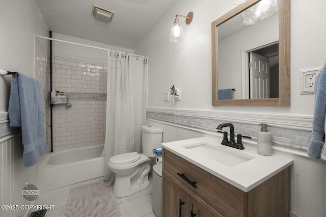 19113 Sarichef Loop, Eagle River, AK 99577 - full bathroom featuring vanity, toilet, shower / bathtub combination with curtain, and a wainscoted wall