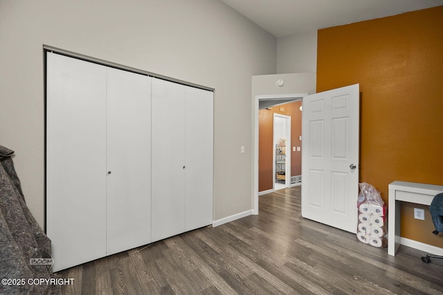19113 Sarichef Loop, Eagle River, AK 99577 - unfurnished bedroom featuring wood finished floors, a closet, baseboards, and high vaulted ceiling