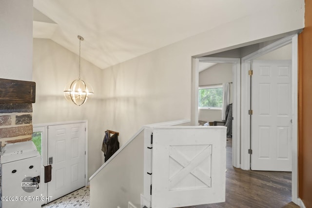 19113 Sarichef Loop, Eagle River, AK 99577 - interior space with vaulted ceiling, a chandelier, and dark wood-type flooring