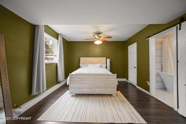 19113 Sarichef Loop, Eagle River, AK 99577 - bedroom with wood finished floors, baseboards, a barn door, and a ceiling fan