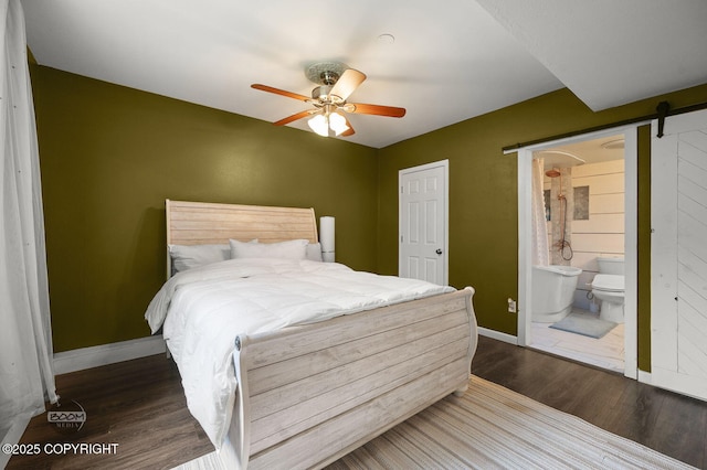 19113 Sarichef Loop, Eagle River, AK 99577 - bedroom with a barn door, wood finished floors, baseboards, ensuite bath, and a ceiling fan