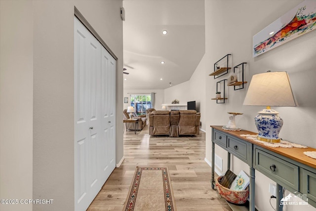 8620 Jade St, Anchorage, AK 99502 - hall with light wood finished floors, lofted ceiling, recessed lighting, and baseboards