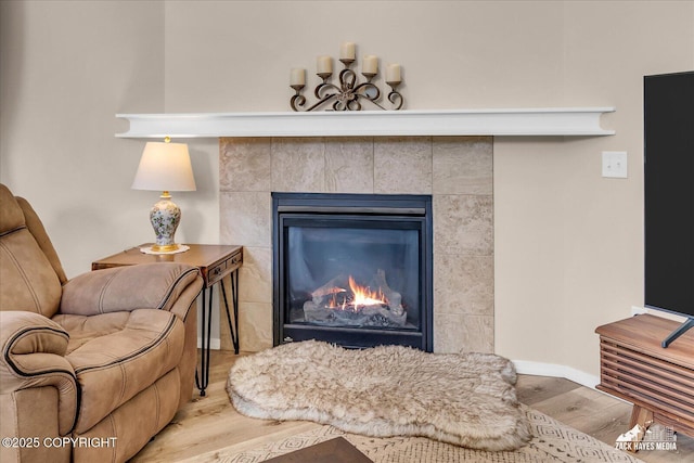 8620 Jade St, Anchorage, AK 99502 - detailed view of wood finished floors, a tile fireplace, and baseboards