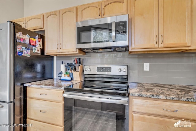 8620 Jade St, Anchorage, AK 99502 - kitchen with stainless steel appliances, light brown cabinets, backsplash, and light stone counters