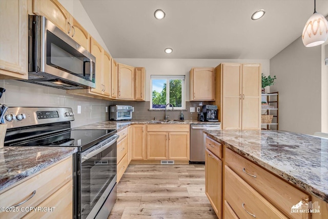 8620 Jade St, Anchorage, AK 99502 - kitchen with stainless steel appliances, light brown cabinetry, a sink, and recessed lighting