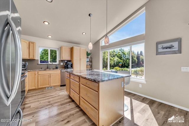 8620 Jade St, Anchorage, AK 99502 - kitchen featuring light brown cabinetry, appliances with stainless steel finishes, a sink, light wood-style floors, and recessed lighting