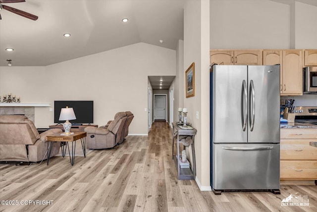 8620 Jade St, Anchorage, AK 99502 - kitchen featuring stainless steel appliances, light brown cabinets, open floor plan, lofted ceiling, and light wood finished floors