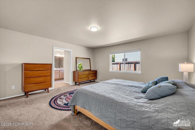 8620 Jade St, Anchorage, AK 99502 - bedroom featuring light carpet, baseboards, and ensuite bath