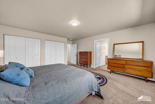 8620 Jade St, Anchorage, AK 99502 - carpeted bedroom featuring multiple closets and baseboards