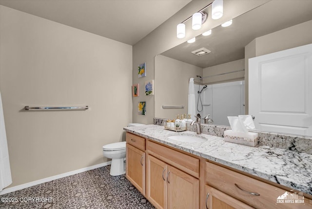 8620 Jade St, Anchorage, AK 99502 - bathroom with a shower, vanity, baseboards, toilet, and tile patterned floors