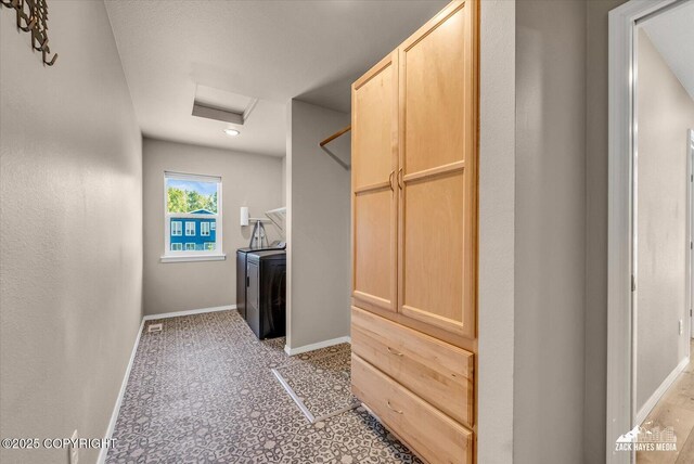 8620 Jade St, Anchorage, AK 99502 - laundry room featuring baseboards and attic access