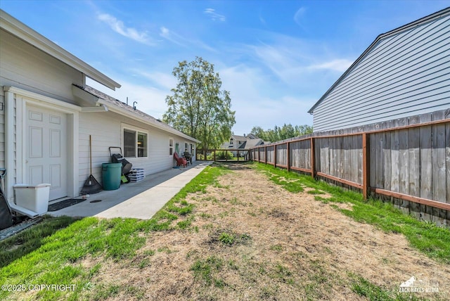 8620 Jade St, Anchorage, AK 99502 - fenced backyard with a patio area
