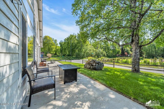 8620 Jade St, Anchorage, AK 99502 - view of patio / terrace with view of wooded area