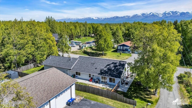 8620 Jade St, Anchorage, AK 99502 - aerial view of property and surrounding area with a mountain backdrop and a heavily wooded area