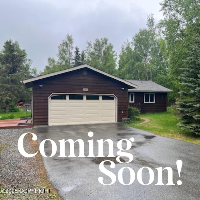 12944 Ridgeview Dr, Anchorage, AK 99516 - rustic home with asphalt driveway, a garage, and a front yard