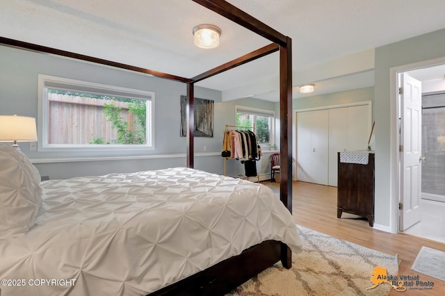 218 Deerfield Dr, Anchorage, AK 99515 - bedroom with light wood-style floors and connected bathroom