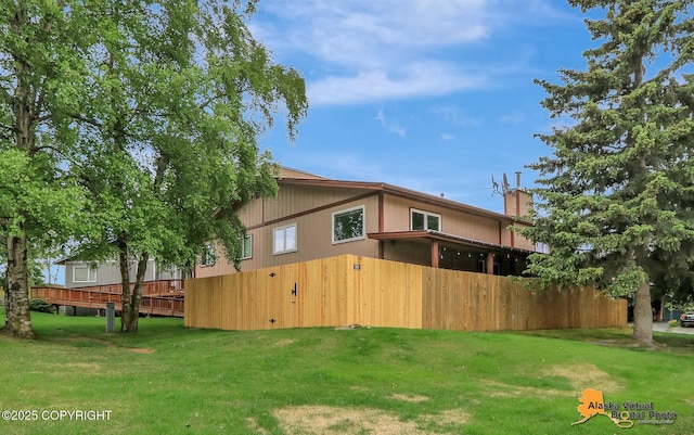 218 Deerfield Dr, Anchorage, AK 99515 - rear view of property featuring a yard and a chimney