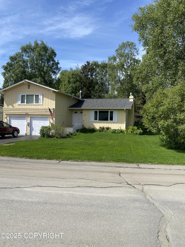 3316 Vassar Dr, Anchorage, AK 99508 - view of front of property with driveway, a front lawn, a garage, and a chimney