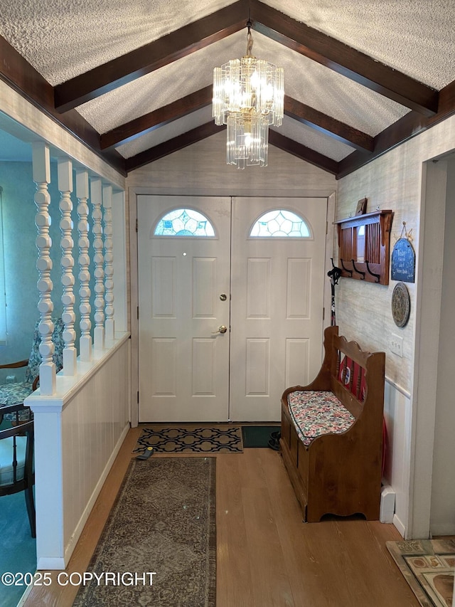 3316 Vassar Dr, Anchorage, AK 99508 - entrance foyer featuring wood finished floors, a chandelier, and a textured ceiling