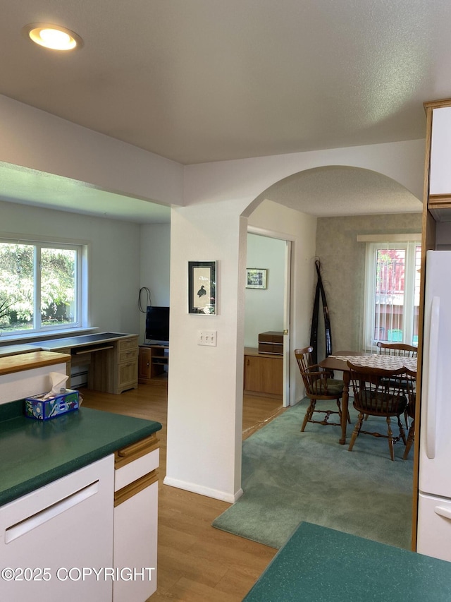 3316 Vassar Dr, Anchorage, AK 99508 - kitchen featuring arched walkways, refrigerator, light wood finished floors, a baseboard radiator, and recessed lighting