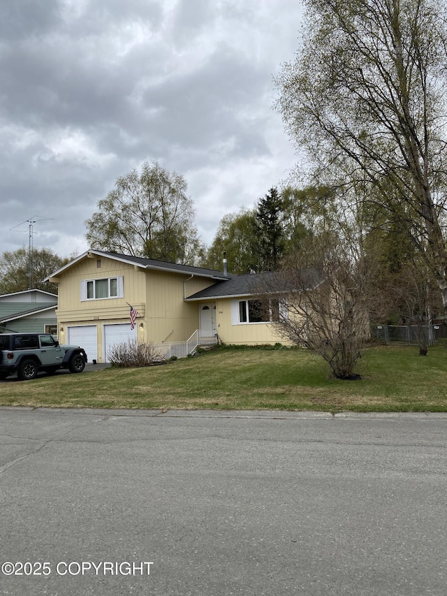 3316 Vassar Dr, Anchorage, AK 99508 - view of front of house with a garage and a front lawn