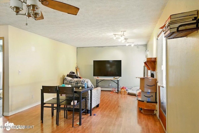4510 Wright St # 25, Anchorage, AK 99507 - dining area featuring wood finished floors, ceiling fan, and a textured ceiling