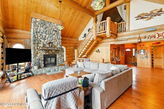 22325 Sterling Hwy, Ninilchik, AK 99639 - living area featuring log walls, high vaulted ceiling, wood ceiling with exposed beams, stairway, and hardwood / wood-style flooring