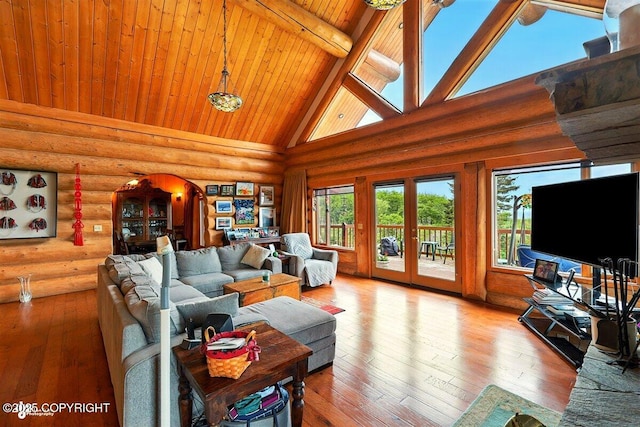22325 Sterling Hwy, Ninilchik, AK 99639 - living room featuring high vaulted ceiling, wood ceiling with exposed beams, rustic walls, wood-type flooring, and arched walkways