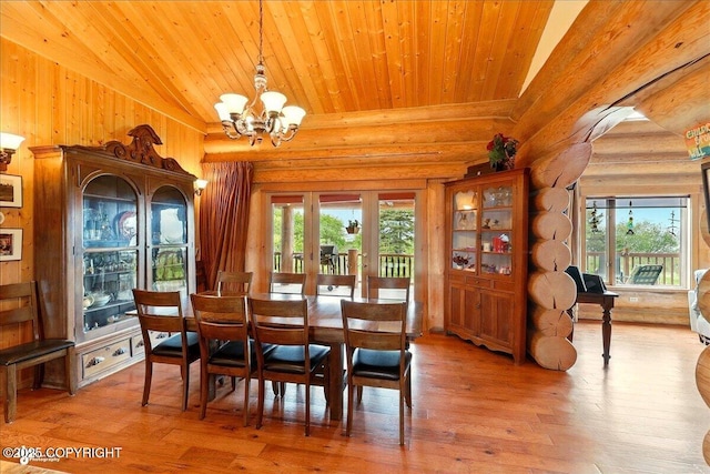 22325 Sterling Hwy, Ninilchik, AK 99639 - dining space featuring a chandelier, rustic walls, wood-type flooring, wooden ceiling, and vaulted ceiling