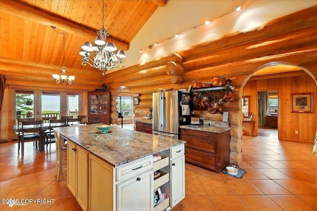 22325 Sterling Hwy, Ninilchik, AK 99639 - kitchen featuring freestanding refrigerator, wooden ceiling with exposed beams, arched walkways, a chandelier, and light tile patterned flooring
