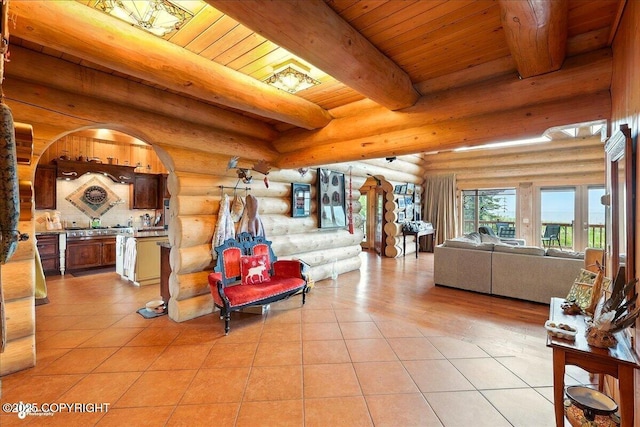 22325 Sterling Hwy, Ninilchik, AK 99639 - living area featuring rustic walls, wooden ceiling with exposed beams, and light tile patterned flooring