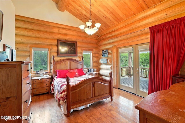 22325 Sterling Hwy, Ninilchik, AK 99639 - bedroom with access to outside, french doors, a chandelier, rustic walls, and light wood finished floors