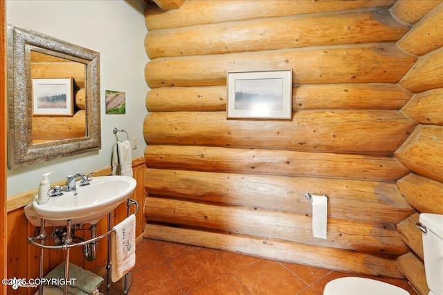 22325 Sterling Hwy, Ninilchik, AK 99639 - half bath featuring toilet, a sink, tile patterned floors, and log walls