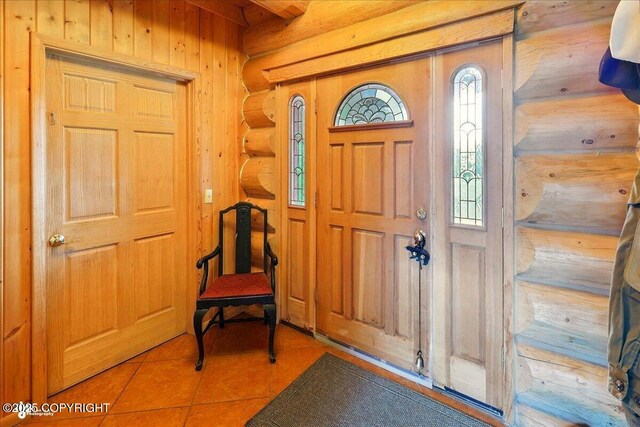 22325 Sterling Hwy, Ninilchik, AK 99639 - foyer entrance featuring tile patterned floors, wooden walls, and log walls