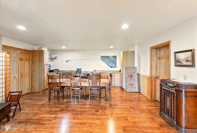 22325 Sterling Hwy, Ninilchik, AK 99639 - dining area featuring light wood-style floors, a wainscoted wall, and recessed lighting
