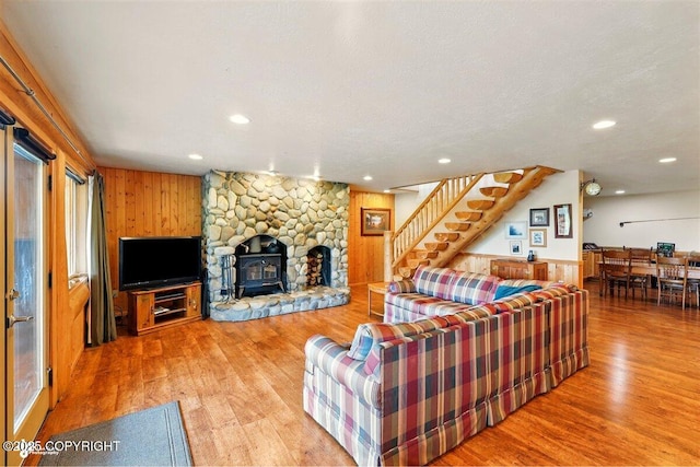 22325 Sterling Hwy, Ninilchik, AK 99639 - living room featuring stairs, wood finished floors, a wood stove, recessed lighting, and wooden walls