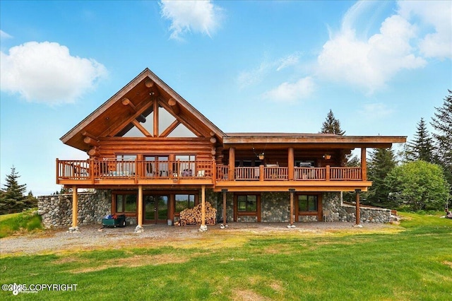 22325 Sterling Hwy, Ninilchik, AK 99639 - back of house with log exterior, a yard, a wooden deck, and stone siding
