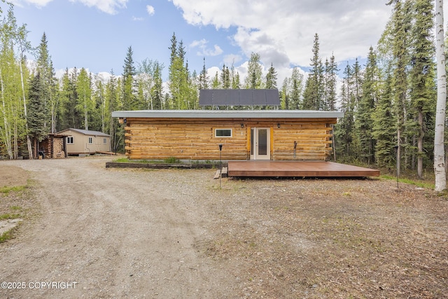 2390 Hermits Way N, Pole, AK 99705 - log cabin with a wooden deck and log siding