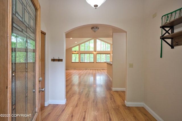 11838 N Hagion Shores Dr, Willow, AK 99688 - hallway with arched walkways, light wood-type flooring, and baseboards
