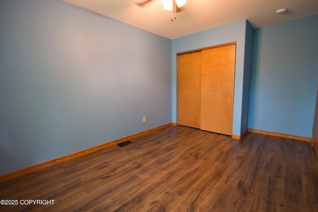 11838 N Hagion Shores Dr, Willow, AK 99688 - unfurnished bedroom with wood finished floors, baseboards, a closet, and a ceiling fan
