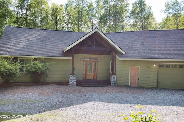 11838 N Hagion Shores Dr, Willow, AK 99688 - view of front of home with an attached garage, gravel driveway, and a shingled roof
