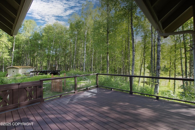 11838 N Hagion Shores Dr, Willow, AK 99688 - deck with a storage shed and a view of trees