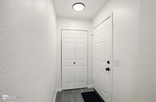 557 N Glenn Hwy, Palmer, AK 99645 - doorway to outside featuring dark wood finished floors, a textured wall, and baseboards