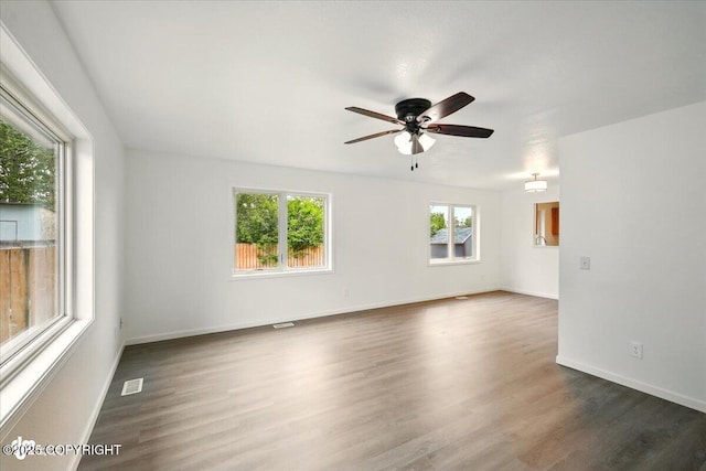 557 N Glenn Hwy, Palmer, AK 99645 - empty room featuring a ceiling fan, dark wood-style floors, and baseboards