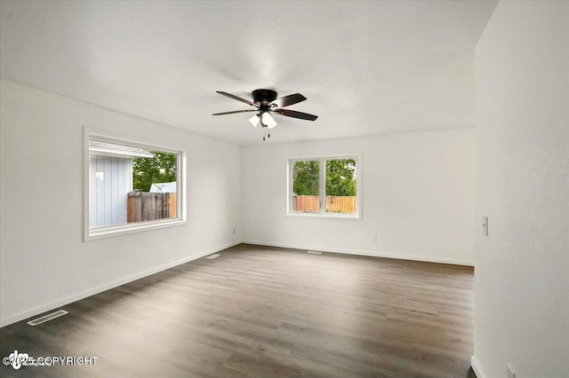 557 N Glenn Hwy, Palmer, AK 99645 - spare room with plenty of natural light, a ceiling fan, and dark wood-style floors