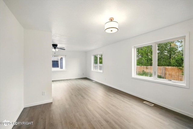557 N Glenn Hwy, Palmer, AK 99645 - unfurnished room featuring baseboards, wood finished floors, and a ceiling fan