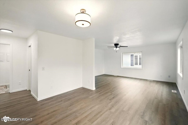 557 N Glenn Hwy, Palmer, AK 99645 - empty room featuring a ceiling fan, wood finished floors, and baseboards