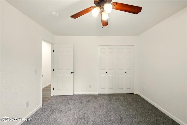 557 N Glenn Hwy, Palmer, AK 99645 - unfurnished bedroom featuring carpet flooring, baseboards, a closet, and a ceiling fan