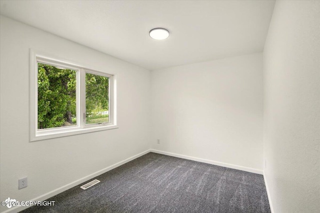 557 N Glenn Hwy, Palmer, AK 99645 - spare room featuring dark colored carpet and baseboards
