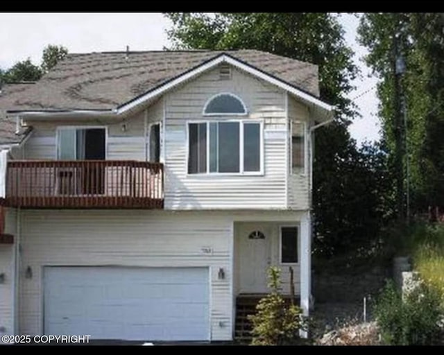 7252 Glade Pl # 4, Anchorage, AK 99518 - view of front of house with a balcony, an attached garage, and asphalt driveway